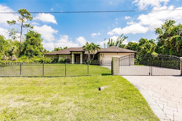 view of front facade with a front yard, stucco siding, a garage, a fenced front yard, and decorative driveway