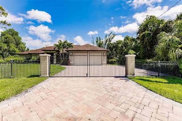 view of gate featuring a yard and a fenced front yard