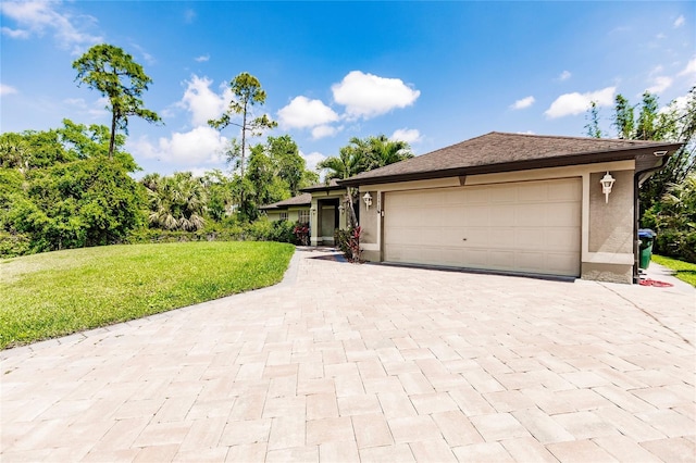 view of front facade featuring decorative driveway, a garage, a front lawn, and stucco siding