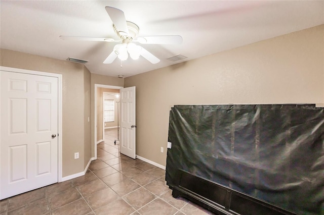 bedroom with tile patterned floors, baseboards, visible vents, and ceiling fan