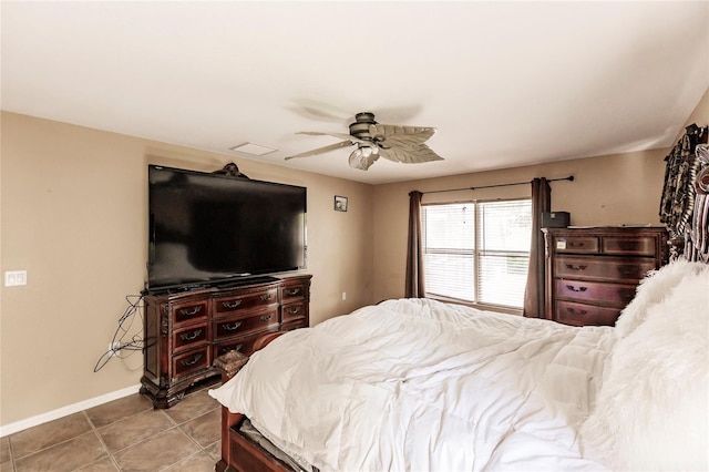 tiled bedroom with baseboards and a ceiling fan