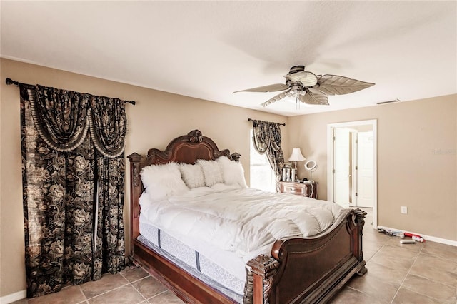 tiled bedroom with visible vents, baseboards, and a ceiling fan