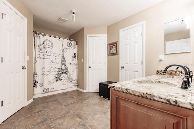 bathroom with vanity, tile patterned floors, a shower with curtain, and visible vents