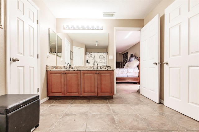 full bath featuring visible vents, double vanity, tile patterned floors, ensuite bath, and a sink