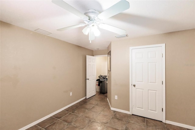 unfurnished bedroom with baseboards, visible vents, and ceiling fan