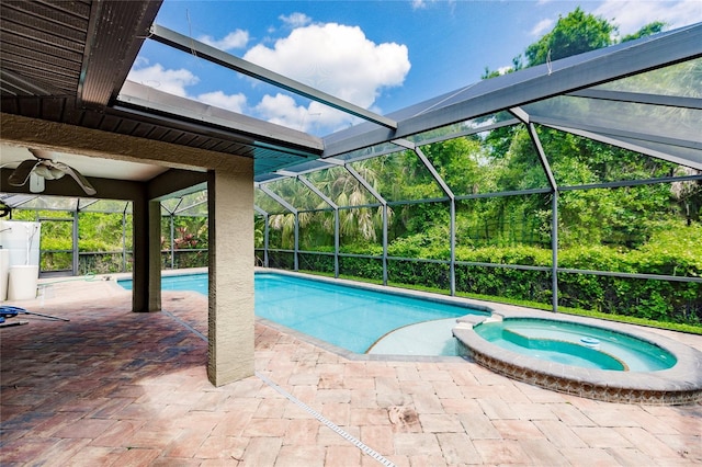 view of swimming pool with a lanai, a patio area, and a pool with connected hot tub