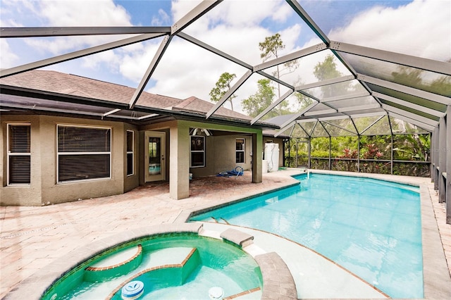 view of pool with a pool with connected hot tub, a lanai, and a patio area