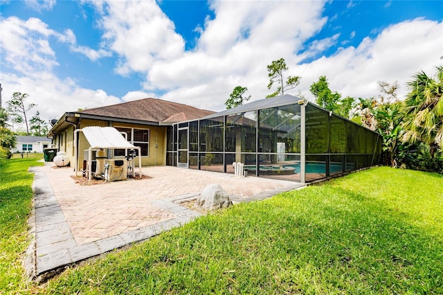 back of house featuring glass enclosure, stucco siding, a yard, an outdoor pool, and a patio