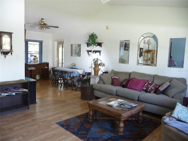 living room with wood finished floors and a ceiling fan