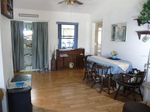 dining space with light wood-style flooring and a ceiling fan