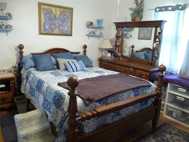 bedroom featuring multiple windows and wood finished floors