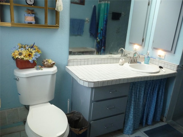 bathroom with tile patterned floors, toilet, and vanity