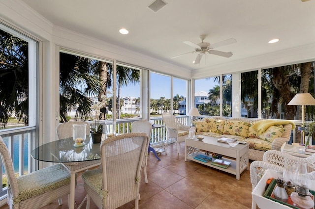 sunroom / solarium featuring a ceiling fan and visible vents