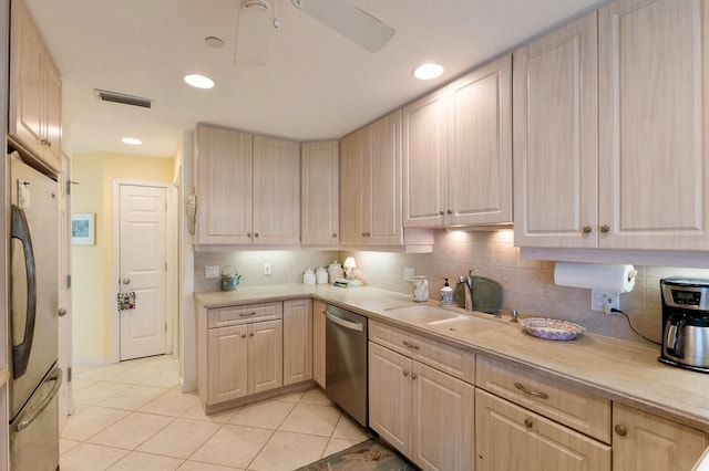 kitchen with a sink, light countertops, tasteful backsplash, and stainless steel appliances