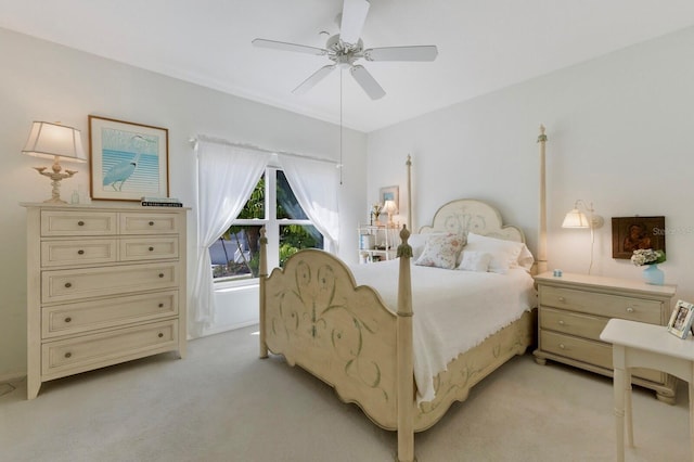 bedroom with light carpet and a ceiling fan