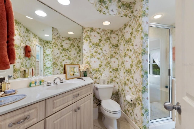 full bathroom featuring vanity, wallpapered walls, a stall shower, tile patterned floors, and toilet