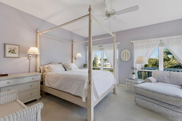 carpeted bedroom featuring access to exterior and a ceiling fan