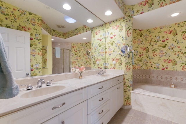 bathroom with a sink, tile patterned floors, and wallpapered walls