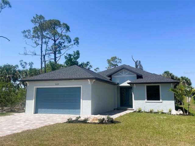 ranch-style house featuring roof with shingles, stucco siding, driveway, an attached garage, and a front lawn