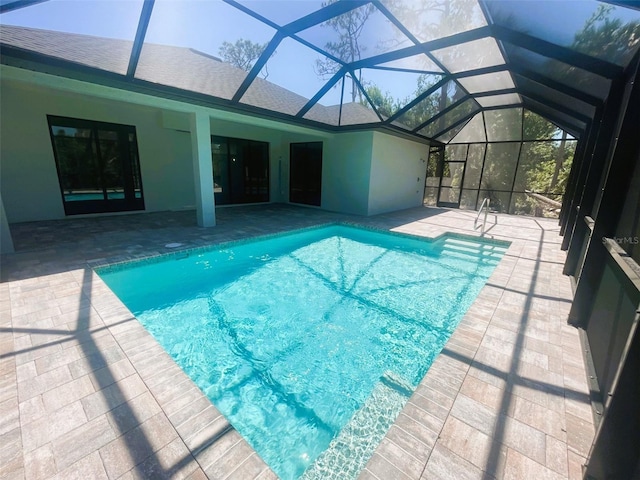 pool featuring a lanai and a patio area