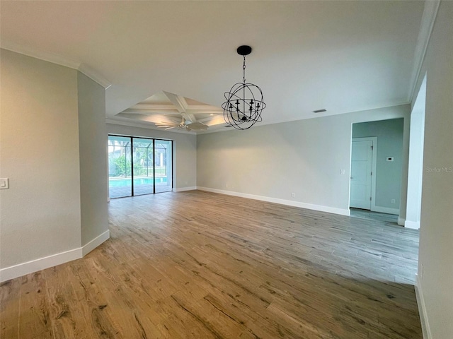 spare room with wood finished floors, baseboards, crown molding, and coffered ceiling
