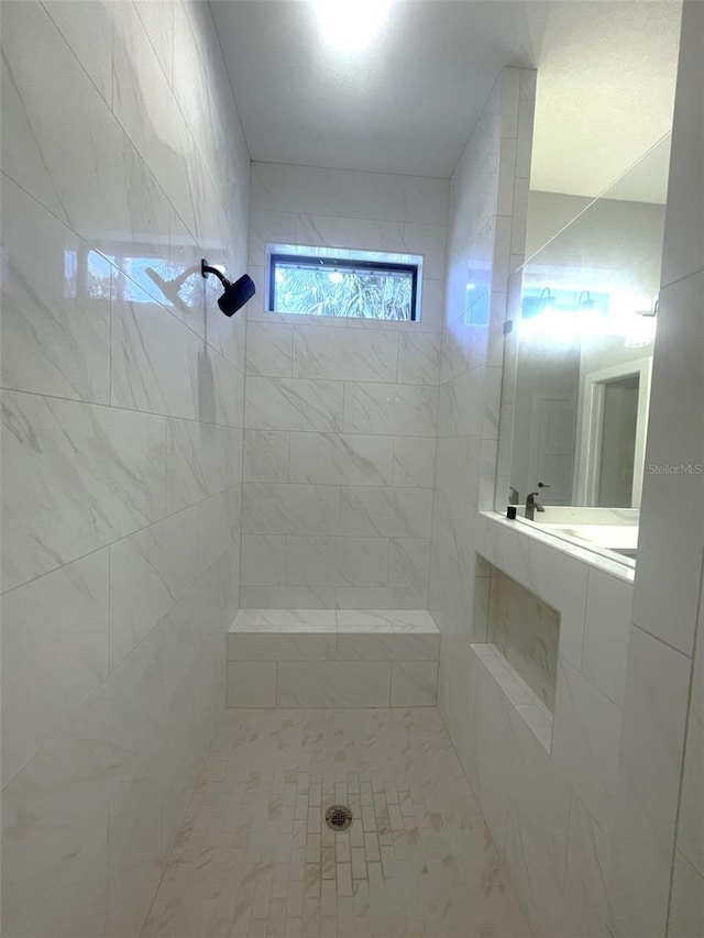 bathroom with tiled shower