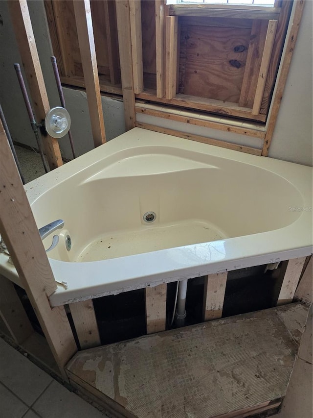 full bath featuring a bath and tile patterned flooring