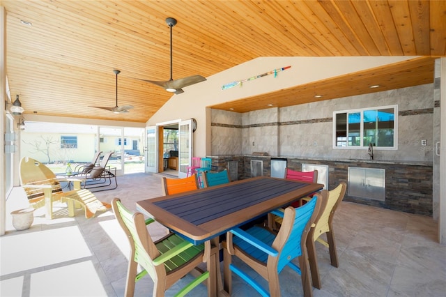 view of patio / terrace with outdoor dining space, ceiling fan, an outdoor kitchen, and a sink