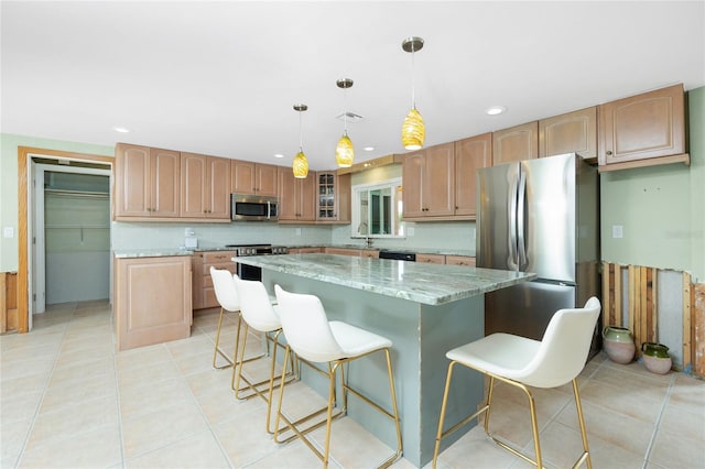 kitchen with light stone counters, visible vents, light tile patterned flooring, appliances with stainless steel finishes, and a center island