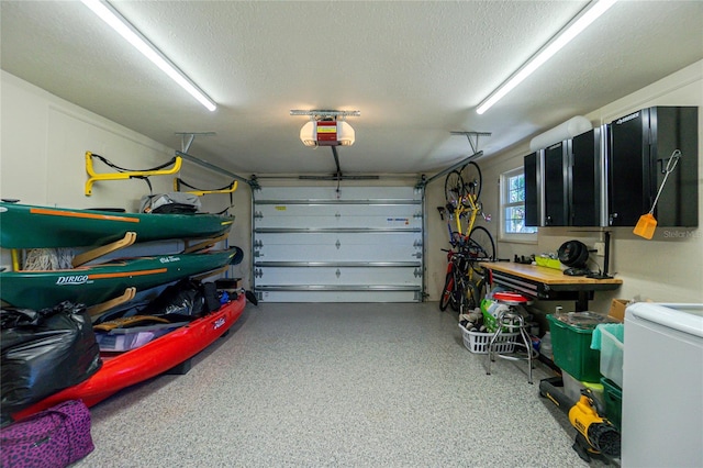 garage featuring washer / dryer and a garage door opener