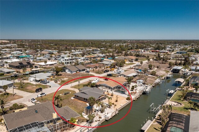 drone / aerial view with a water view and a residential view