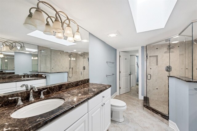 5000 Gasparilla Rd Unit 41B, Boca Grande, FL 33921 - bathroom with a stall shower, a skylight, toilet, vanity, and baseboards