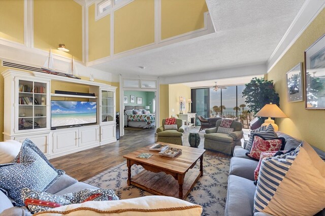 5000 Gasparilla Rd Unit 41B, Boca Grande, FL 33921 - living room with wood finished floors, a textured ceiling, and crown molding