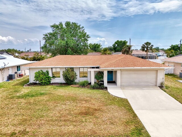 view of front of home featuring central AC unit, an attached garage, concrete driveway, a front yard, and stucco siding