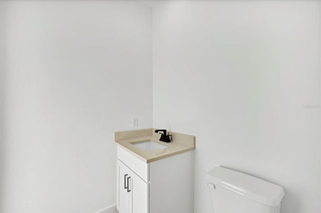 bathroom with toilet and vanity