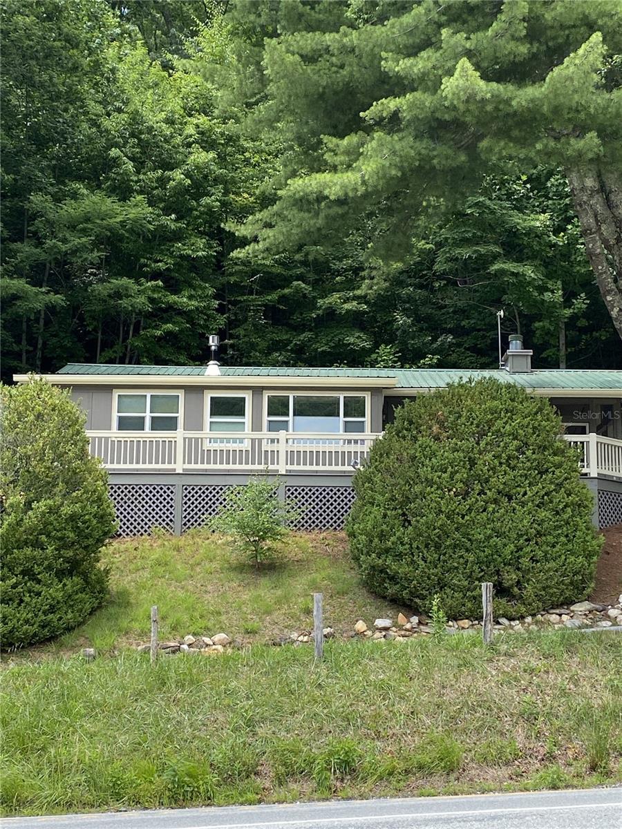 view of front of home with a deck and metal roof