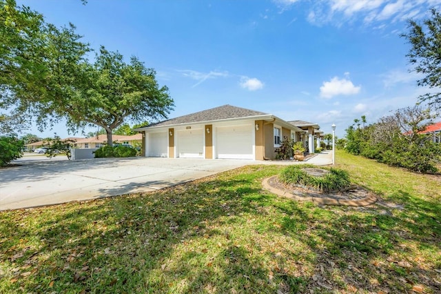 ranch-style home featuring a front lawn, stucco siding, an attached garage, and concrete driveway