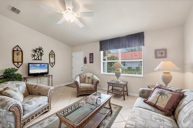 living room featuring baseboards, a ceiling fan, and light tile patterned floors