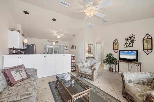 living area featuring visible vents, light tile patterned floors, and a ceiling fan
