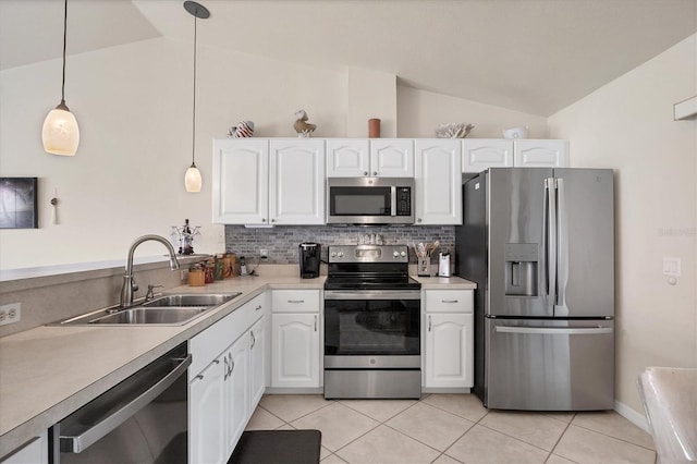 kitchen with white cabinets, a sink, stainless steel appliances, and lofted ceiling