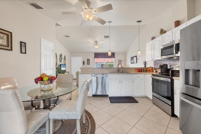 kitchen featuring white cabinetry, light tile patterned floors, a sink, visible vents, and appliances with stainless steel finishes