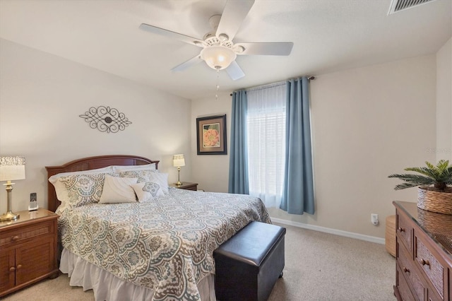 bedroom with light carpet, baseboards, visible vents, and ceiling fan