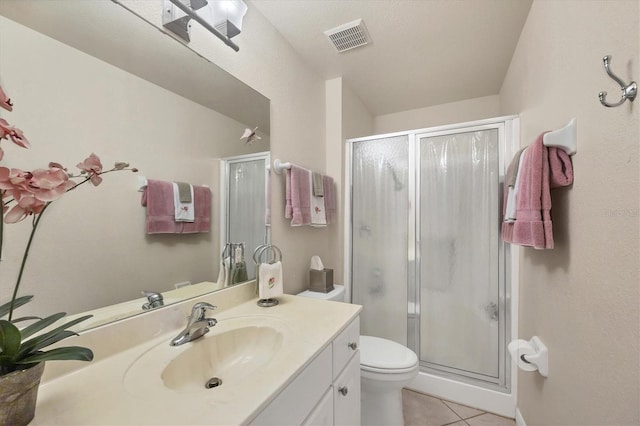 bathroom with a shower stall, tile patterned floors, visible vents, and vanity
