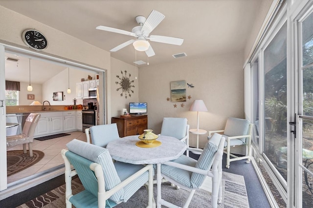 dining room featuring visible vents, light tile patterned floors, and a ceiling fan