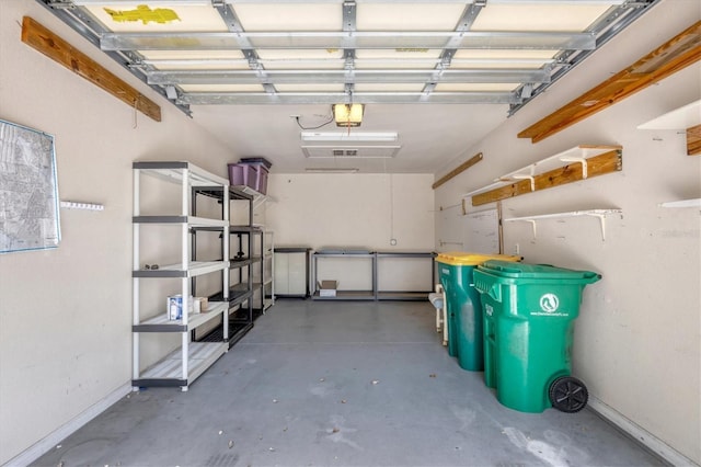 garage with baseboards and a garage door opener