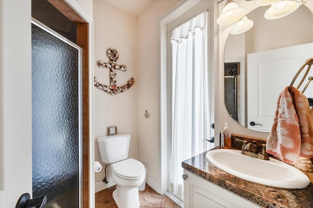 14810 Ingraham Blvd, Port Charlotte, FL 33981 - bathroom featuring a stall shower, toilet, vanity, tile patterned flooring, and baseboards