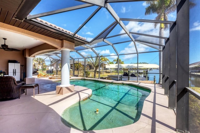 14810 Ingraham Blvd, Port Charlotte, FL 33981 - swimming pool with a patio, glass enclosure, a ceiling fan, a water view, and a dock