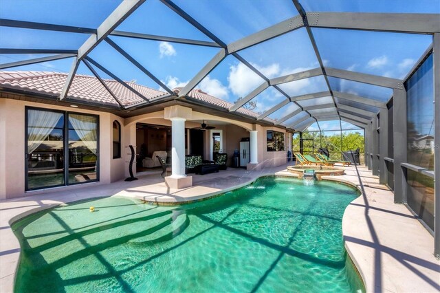 14810 Ingraham Blvd, Port Charlotte, FL 33981 - rear view of property featuring a patio area, ceiling fan, a pool with connected hot tub, a tile roof, and stucco siding
