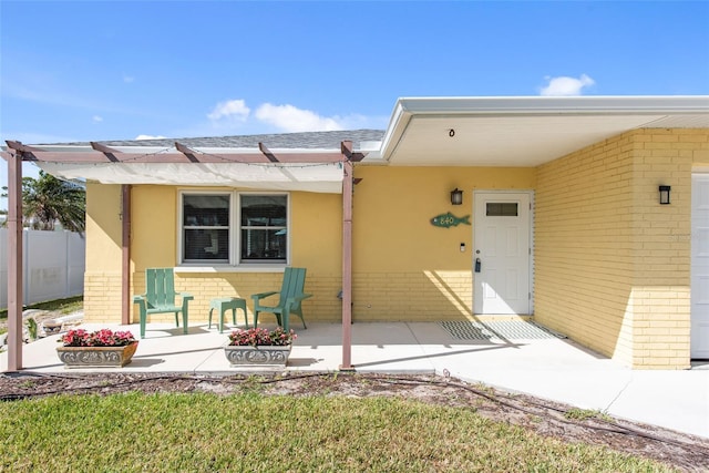 840 Park Rd, Englewood, FL 34223 - doorway to property featuring brick siding, roof with shingles, and stucco siding