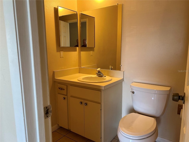 bathroom with vanity, tile patterned floors, and toilet